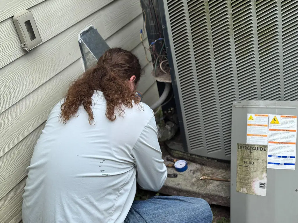 Air Monkey technician working on a residential condenser unit